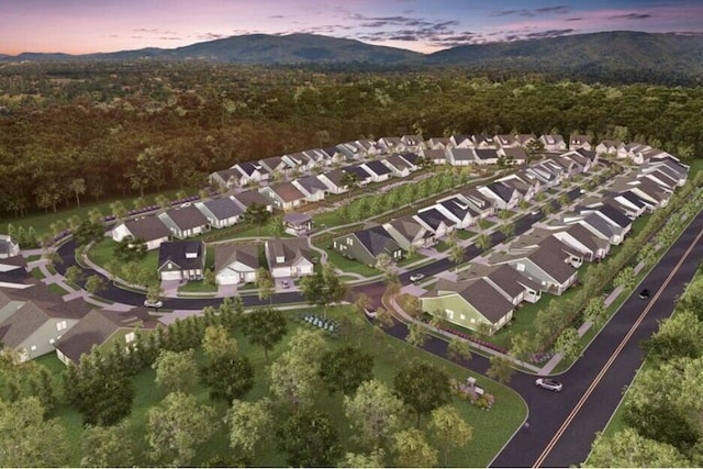 aerial view at dusk featuring a mountain view and a residential view