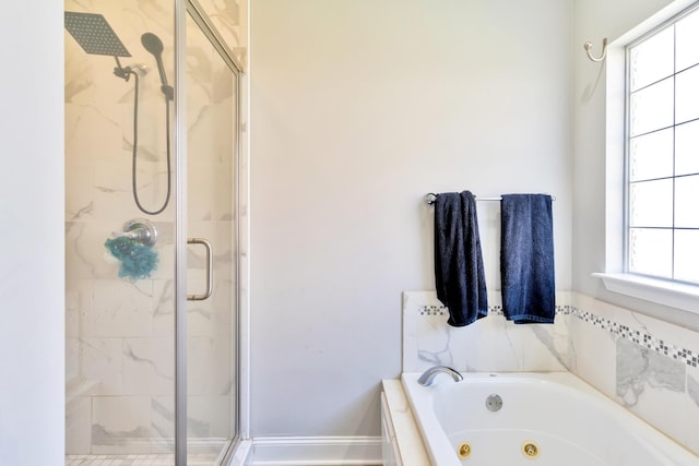 full bathroom featuring a tub with jets and a shower stall