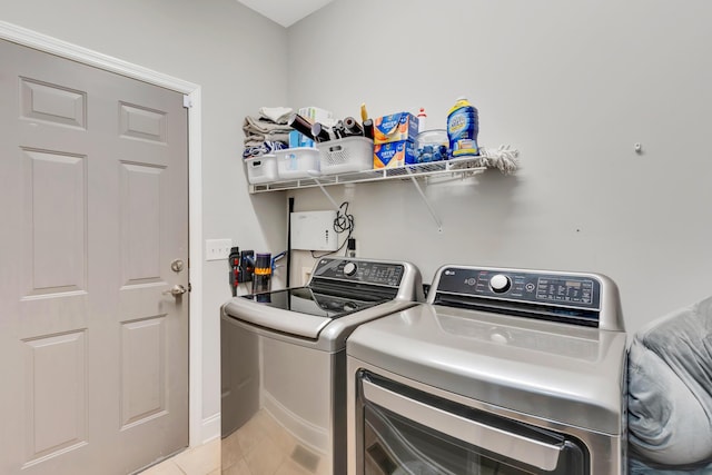 laundry area featuring washer and dryer, laundry area, and light tile patterned floors