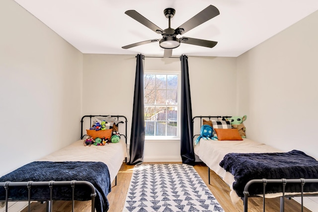 bedroom with a ceiling fan and wood finished floors