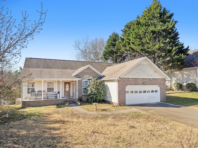 ranch-style home featuring a porch, an attached garage, concrete driveway, a front lawn, and brick siding