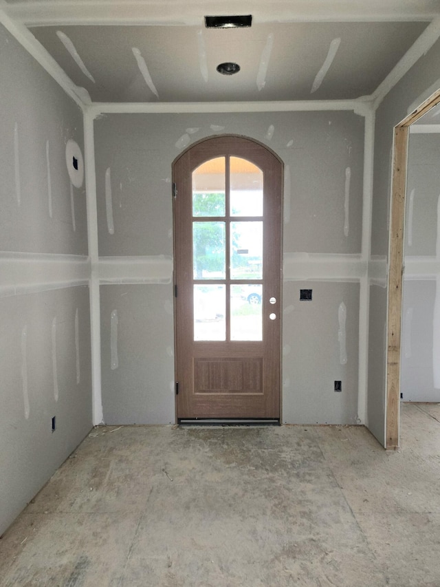 doorway to outside featuring arched walkways