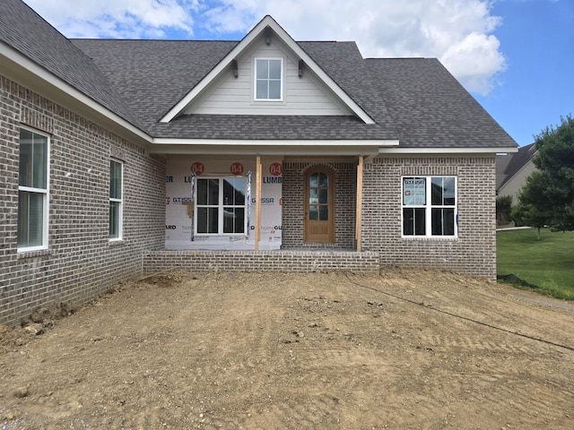12800 Blakeslee Dr Unit 22, Soddy Daisy, TN 37379 - view of front facade with brick siding, covered porch, and a shingled roof