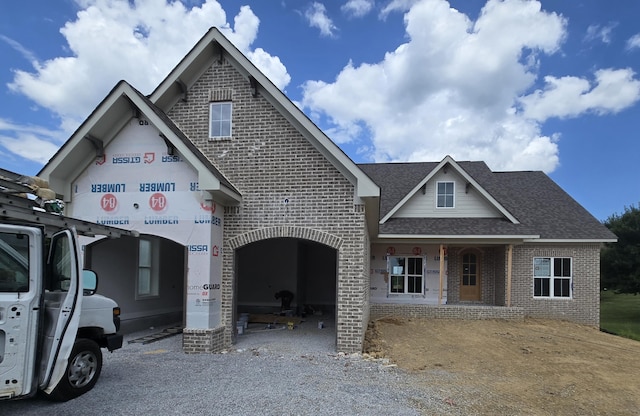 12800 Blakeslee Dr Unit 22, Soddy Daisy, TN 37379 - view of front facade with brick siding, roof with shingles, and driveway