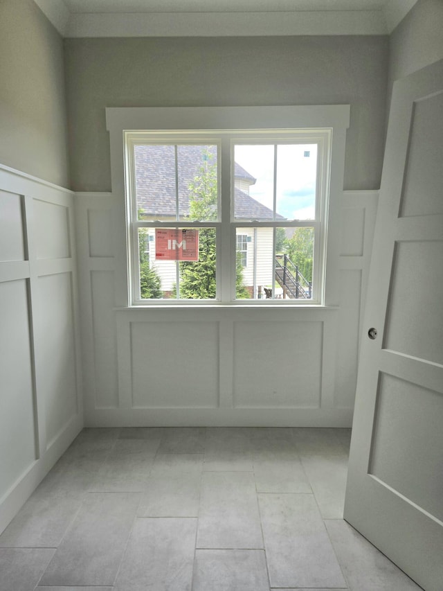 12800 Blakeslee Dr Unit 22, Soddy Daisy, TN 37379 - unfurnished room featuring a decorative wall, a wainscoted wall, and light tile patterned flooring