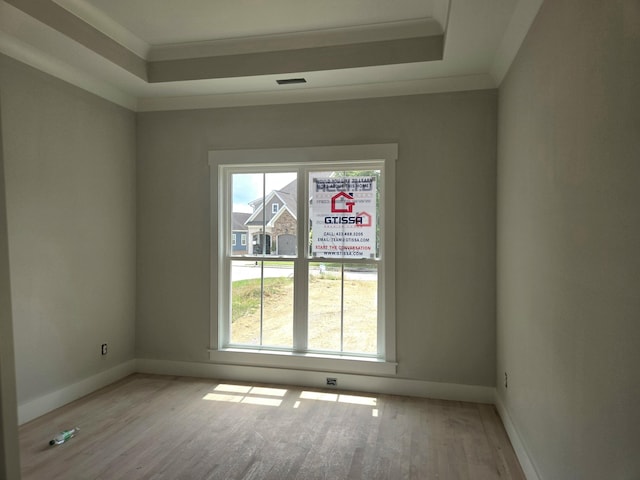 12800 Blakeslee Dr Unit 22, Soddy Daisy, TN 37379 - unfurnished room featuring plenty of natural light, wood finished floors, a tray ceiling, and ornamental molding
