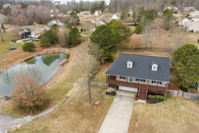 drone / aerial view featuring a residential view and a water view