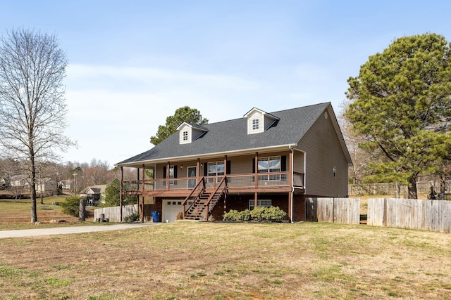 view of front of home with a porch, fence, concrete driveway, an attached garage, and a front yard