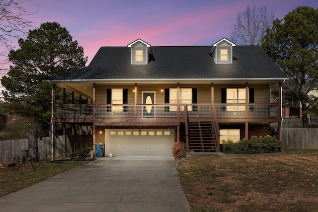 view of front of home with stairway, fence, driveway, covered porch, and a lawn