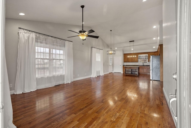 unfurnished living room featuring baseboards, lofted ceiling, recessed lighting, dark wood-style flooring, and ceiling fan