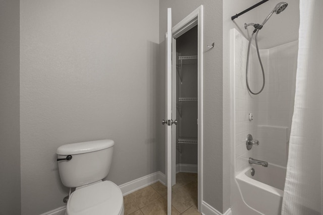 full bathroom featuring tile patterned flooring, shower / bath combination with curtain, toilet, and baseboards