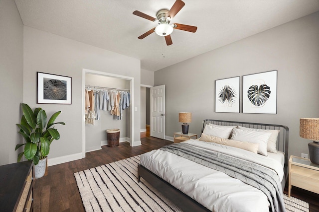 bedroom with wood finished floors, baseboards, a closet, and ceiling fan