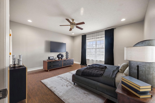 bedroom featuring recessed lighting, baseboards, dark wood finished floors, and a ceiling fan