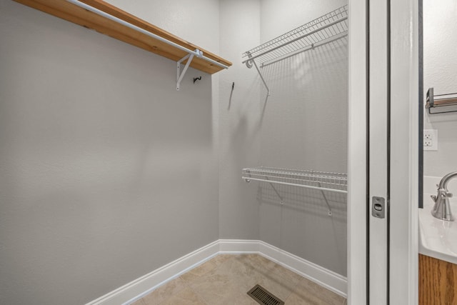 spacious closet featuring visible vents