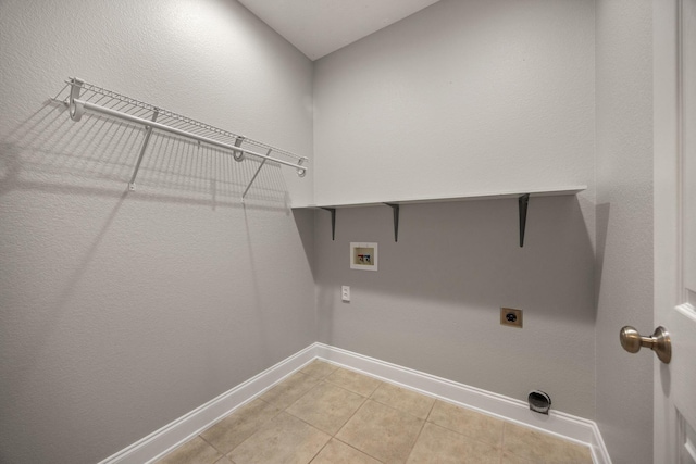 laundry room with hookup for a washing machine, light tile patterned floors, baseboards, laundry area, and electric dryer hookup