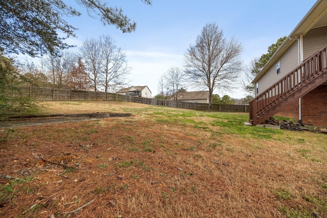 view of yard featuring stairway and a fenced backyard