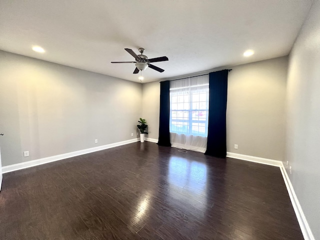 spare room featuring a ceiling fan, recessed lighting, wood finished floors, and baseboards