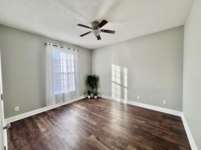 spare room featuring ceiling fan, baseboards, a textured ceiling, and wood finished floors