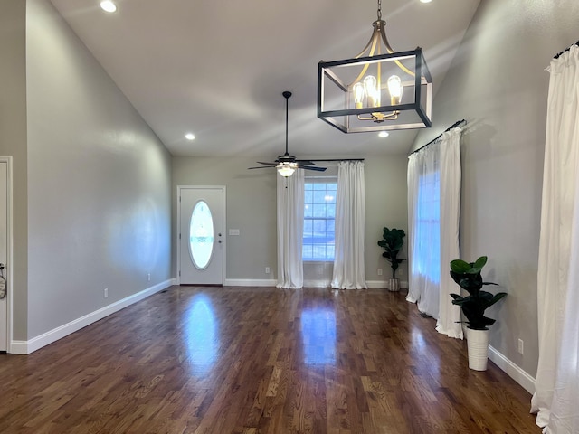 foyer entrance with dark wood finished floors, vaulted ceiling, recessed lighting, and baseboards