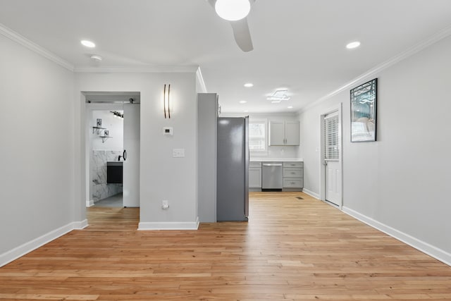 kitchen featuring baseboards, recessed lighting, ornamental molding, stainless steel appliances, and light wood-style floors