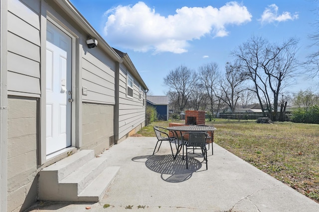 view of patio featuring outdoor dining space and entry steps