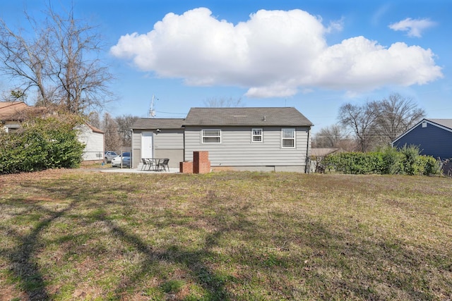 rear view of property with a lawn and a patio area