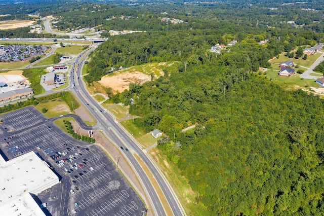 birds eye view of property with a view of trees