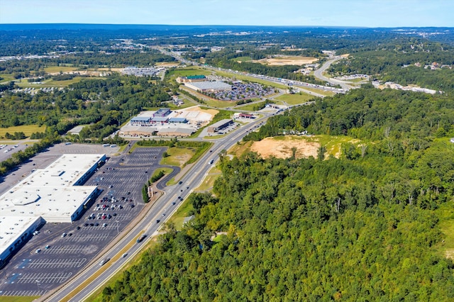 birds eye view of property featuring a wooded view