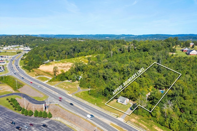 aerial view featuring a wooded view