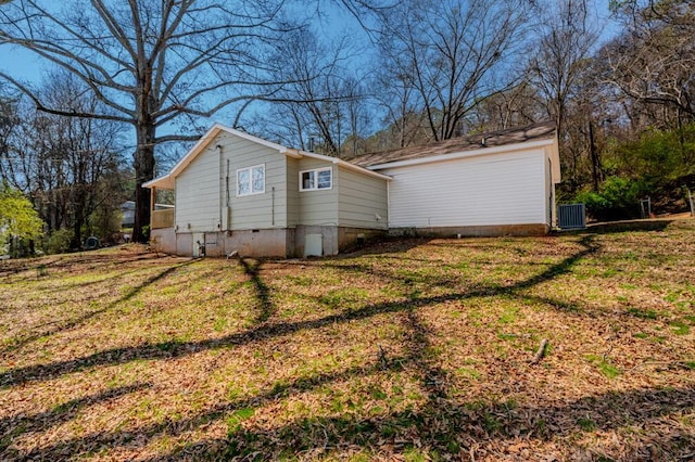 exterior space with cooling unit, a yard, and crawl space