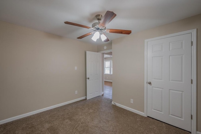 unfurnished bedroom featuring a ceiling fan, baseboards, and carpet floors