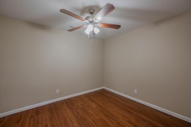 spare room with a ceiling fan, baseboards, and wood finished floors