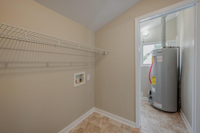 laundry area featuring water heater, laundry area, baseboards, and washer hookup