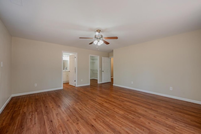 interior space with wood finished floors, baseboards, and ceiling fan