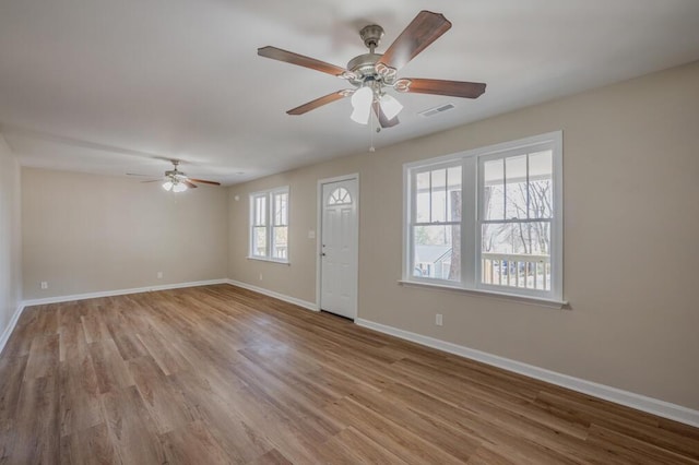 entrance foyer featuring visible vents, wood finished floors, baseboards, and ceiling fan