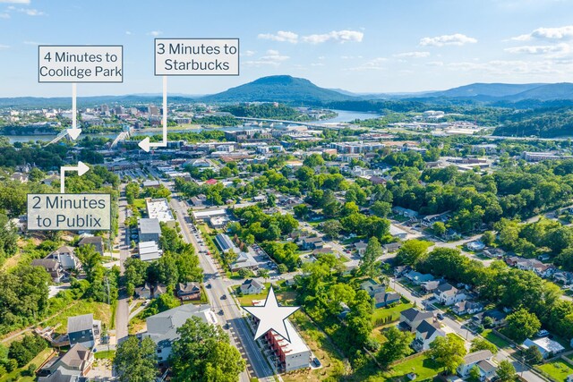 birds eye view of property with a water and mountain view