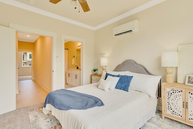 bedroom with a wall mounted air conditioner, ornamental molding, a ceiling fan, ensuite bathroom, and a sink