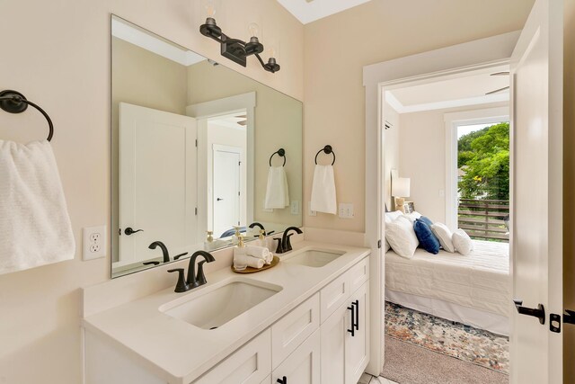 bathroom featuring double vanity, ensuite bath, and a sink