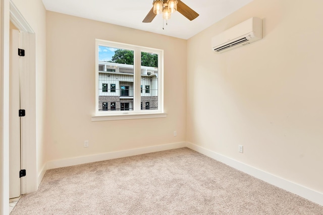 carpeted spare room featuring a wall mounted air conditioner, baseboards, and ceiling fan