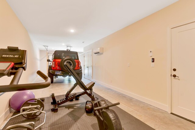 workout area with recessed lighting, a wall mounted AC, and baseboards