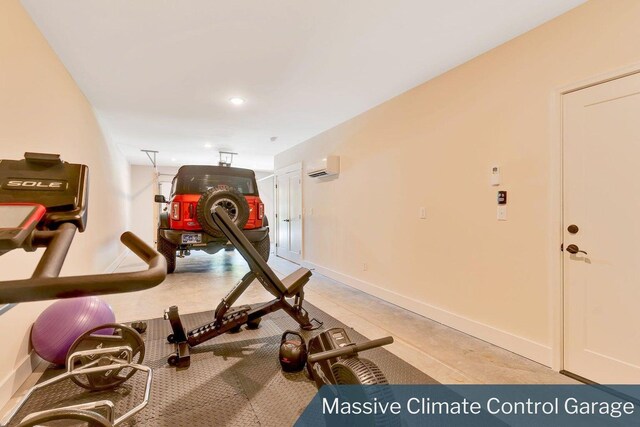 workout area with baseboards and a wall mounted air conditioner