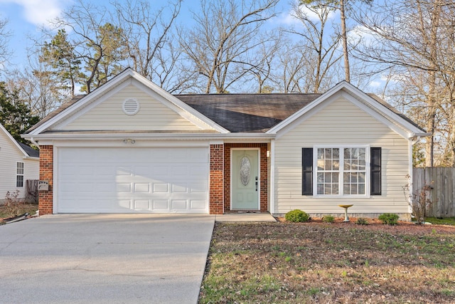 ranch-style house featuring concrete driveway, an attached garage, fence, and brick siding