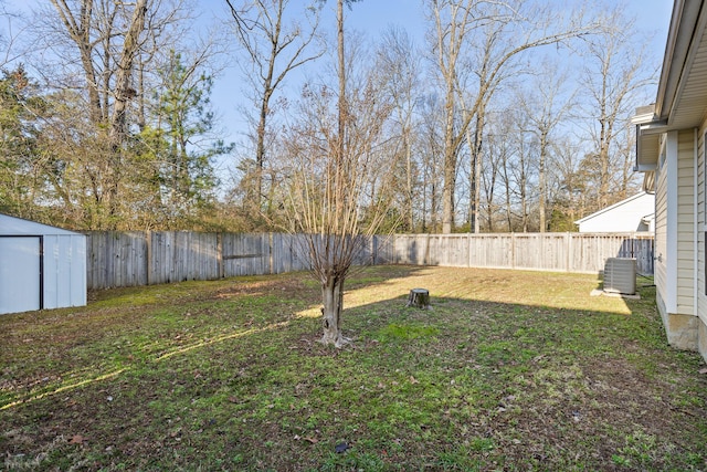 view of yard with a storage unit, an outdoor structure, and a fenced backyard