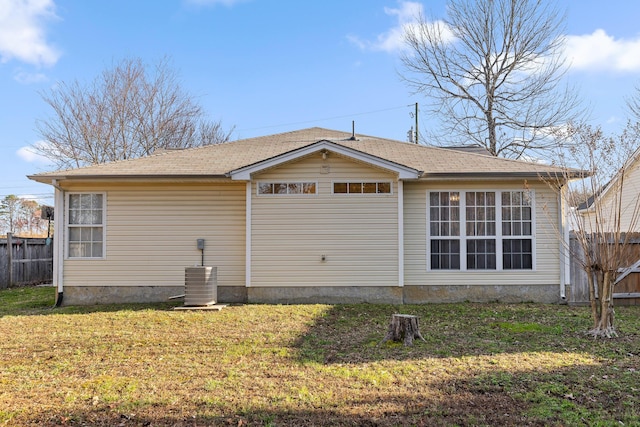 view of home's exterior with a yard, central air condition unit, and fence