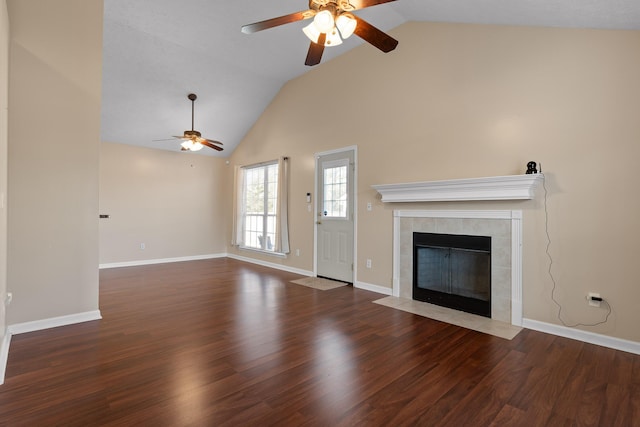 unfurnished living room featuring wood finished floors, baseboards, high vaulted ceiling, ceiling fan, and a tile fireplace