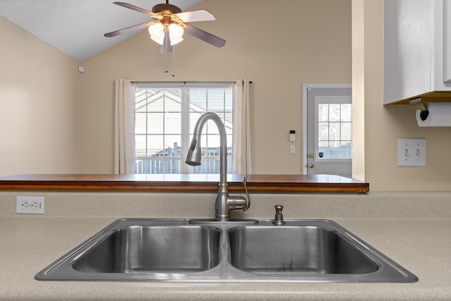 interior details featuring light countertops, ceiling fan, and a sink