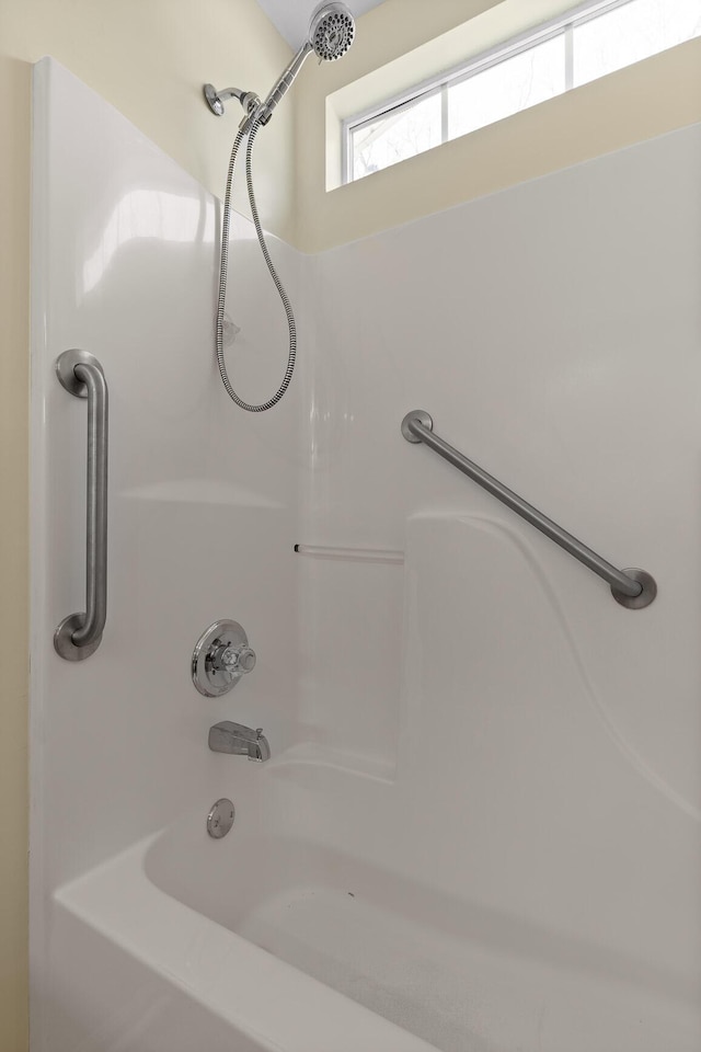 bathroom with bathing tub / shower combination