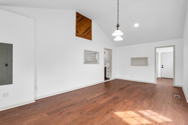 unfurnished living room with visible vents, baseboards, electric panel, wood finished floors, and high vaulted ceiling