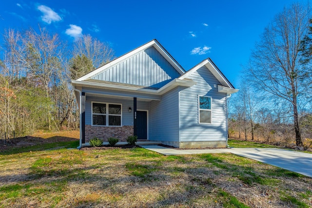 view of front of house with a front yard and board and batten siding