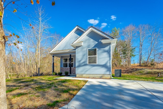 view of front of house featuring a front yard, a porch, and board and batten siding